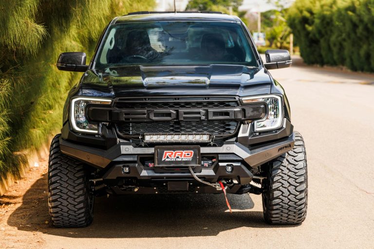 Front view of a customized Ford truck featuring a RAD off-road kit, parked outdoors.